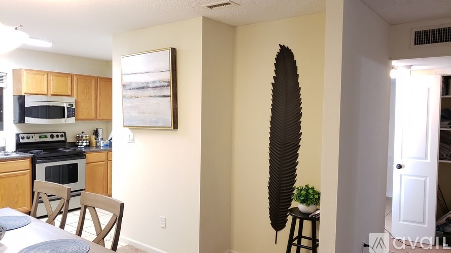 A kitchen with a dining table and chairs.