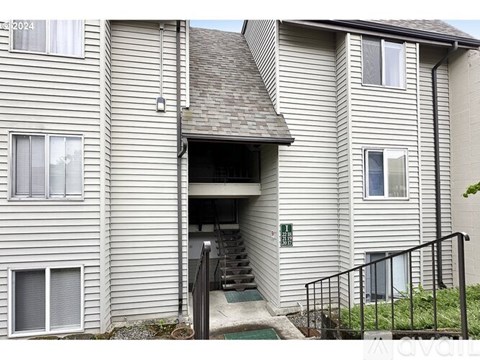 A building with a garage door open and a sign that says "AVAILABLE".