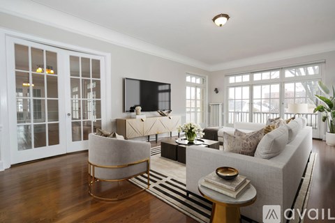 A living room with a grey sofa, a round chair and a coffee table.