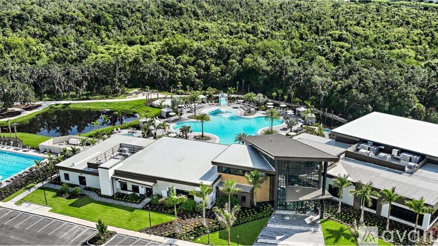 A resort with a swimming pool and a large building.