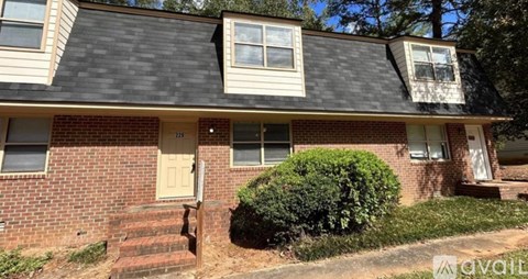 A house with a brick facade and a grey roof.