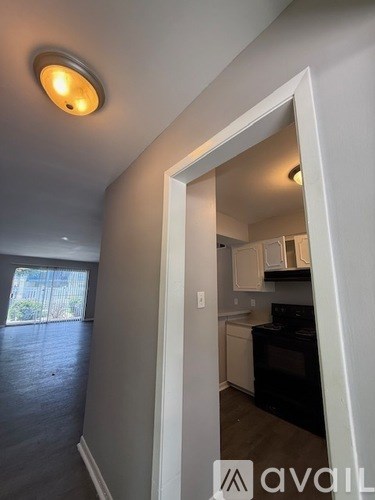 A kitchen area with a black oven and white cabinets.
