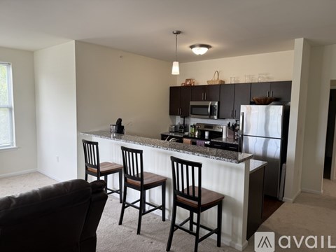 A kitchen with a granite countertop and a refrigerator.