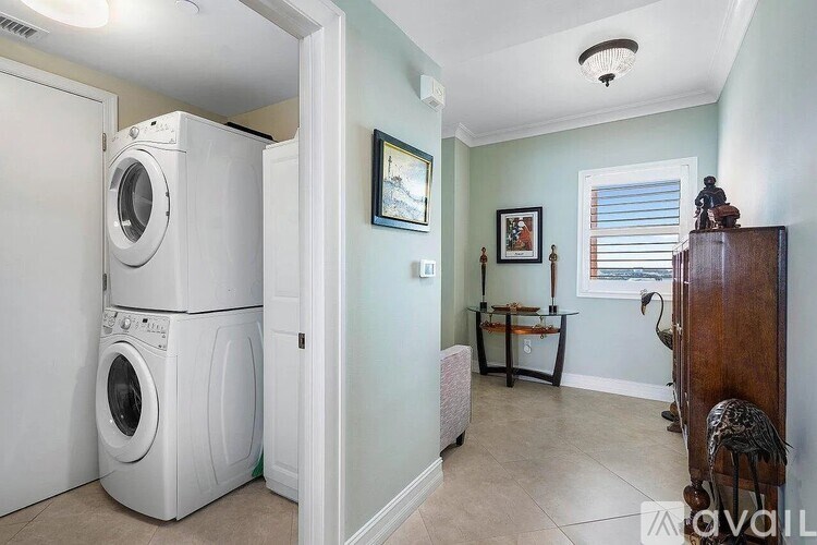 A laundry room with a washer and dryer stacked on top of each other.