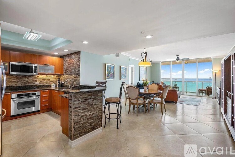 A kitchen with a dining table and chairs is available for rent.