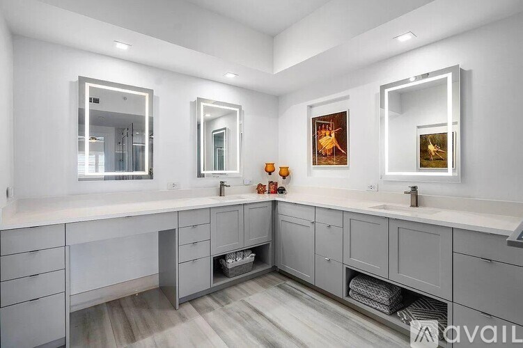 A bathroom with two sinks and a large mirror.