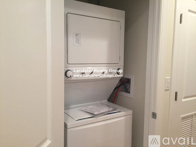 A small white washer and dryer in a small room.