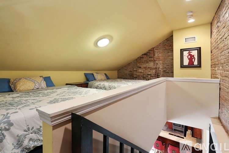 A bedroom with a bed and a picture on the wall.