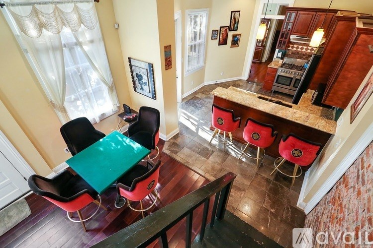 A kitchen with a table and chairs in front of a window.