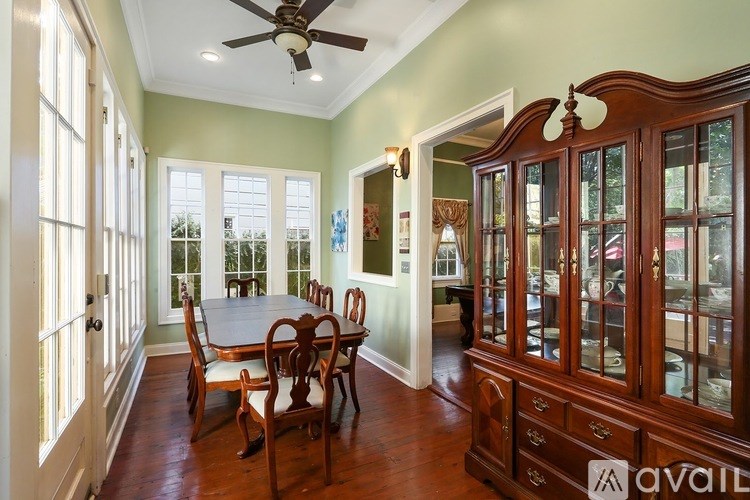 A dining room with a table and chairs.