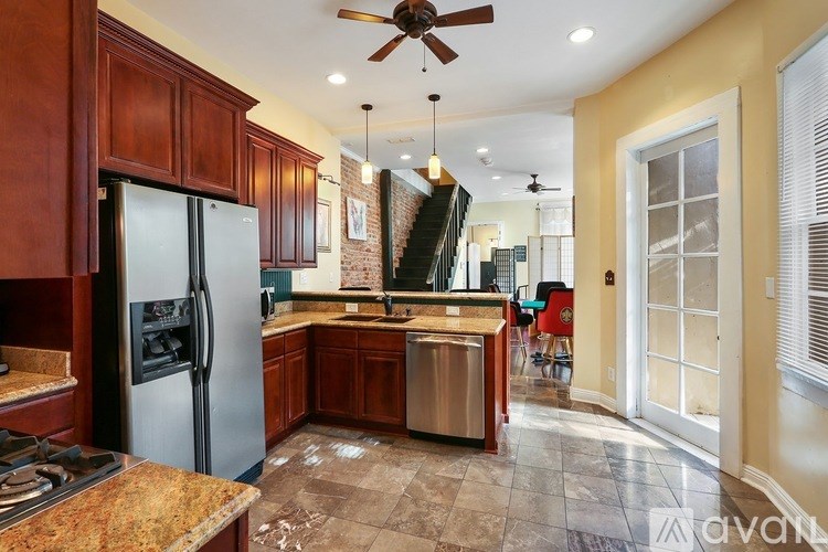 A kitchen with a refrigerator, stove, and oven.