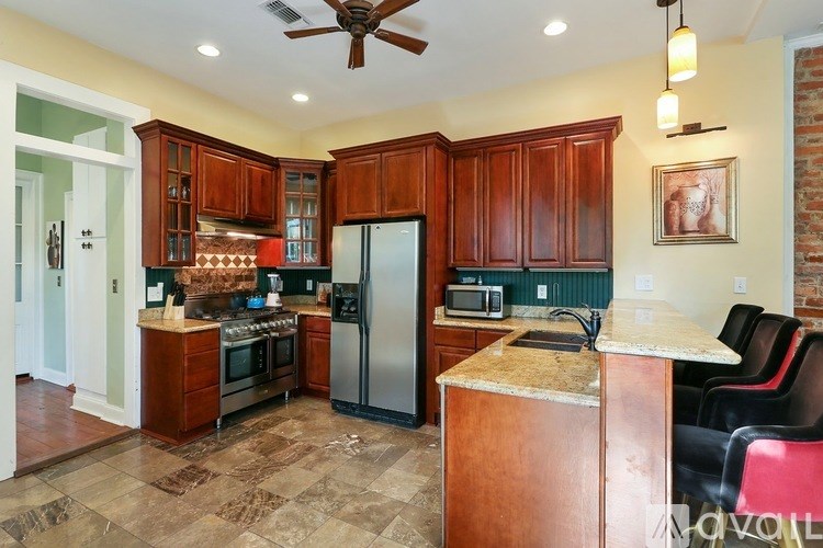 A kitchen with wooden cabinets and a tiled floor.