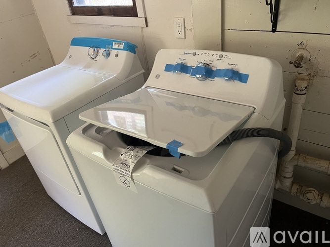 A white washing machine and dryer are taped together.