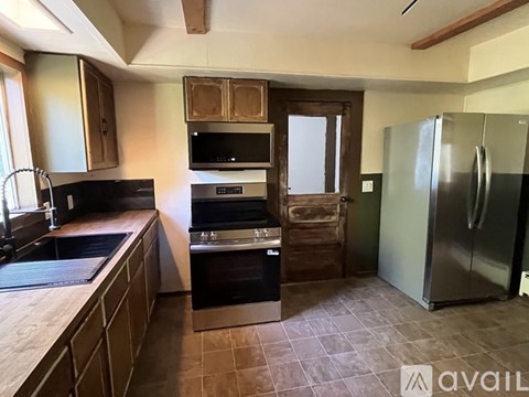 A kitchen with a black oven and a black microwave.
