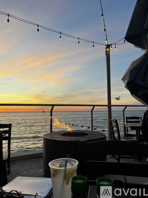 A white bathroom with a marble tile shower and a white bathtub.