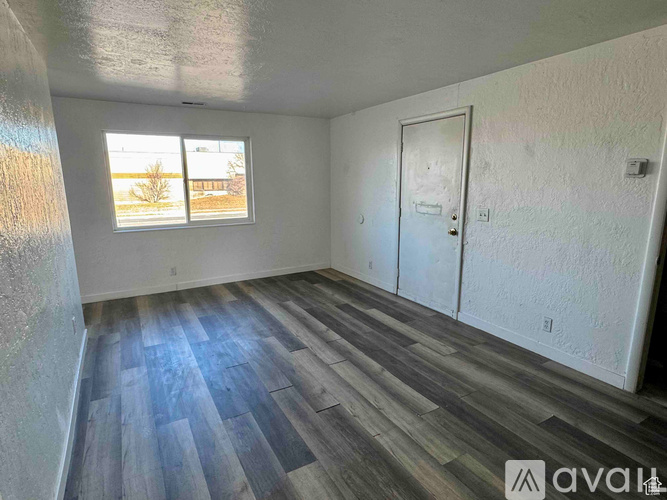 A white bathroom with a toilet, sink, and bathtub.