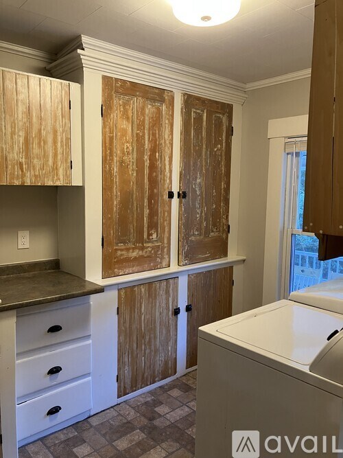 A kitchen with wooden cabinets and a checkered floor.