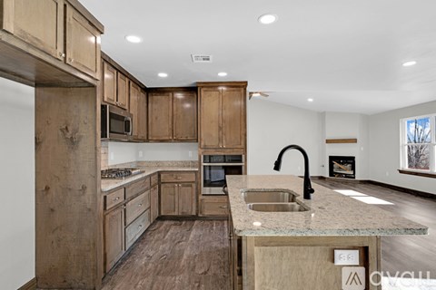 A kitchen with wooden cabinets and a granite countertop.