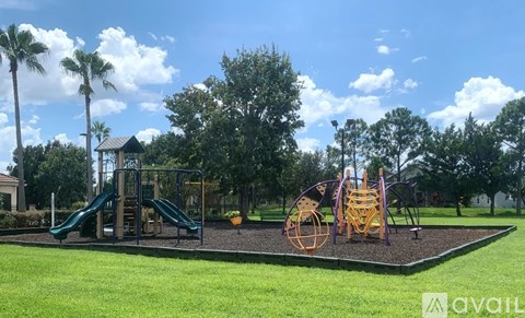 A playground with a green slide and a yellow swing set.