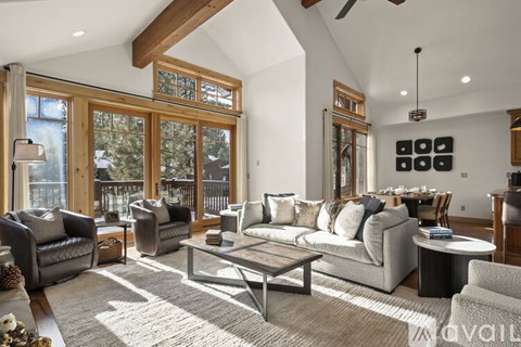 A living room with a grey couch and a coffee table.