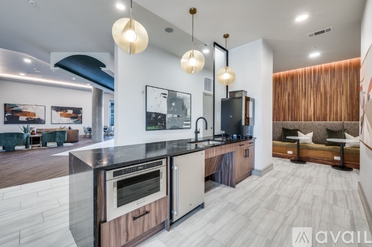 A modern kitchen with a wooden island and stainless steel appliances.