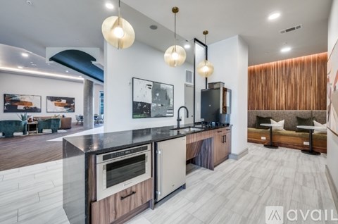 A modern kitchen with a wooden island and stainless steel appliances.