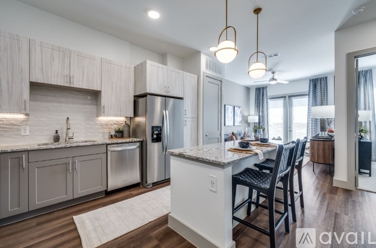 A modern kitchen with a large island and a dining area.