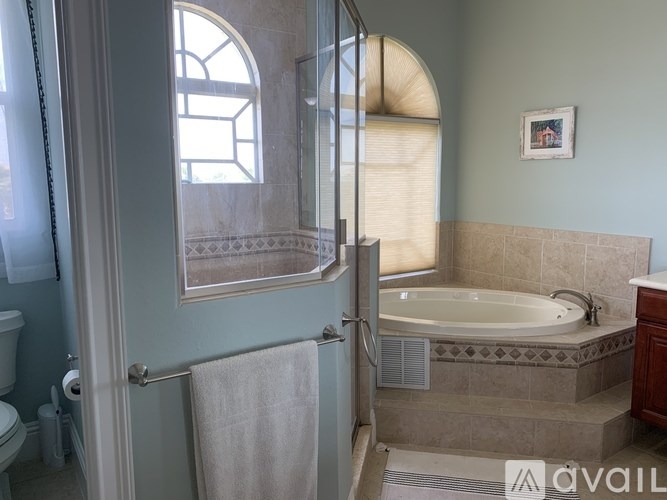 A bathroom with a tub, toilet, and sink.
