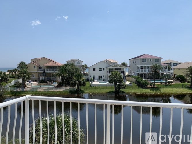 A row of houses with a pool in front of them.