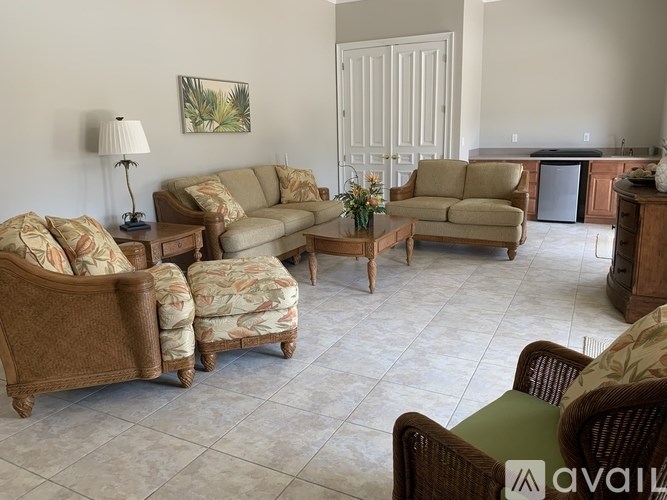 A living room with a sofa, armchair, and end table.