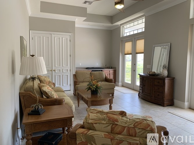 A living room with a sofa, armchair, and coffee table.