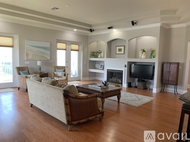 A living room with a couch, a coffee table, and a television.