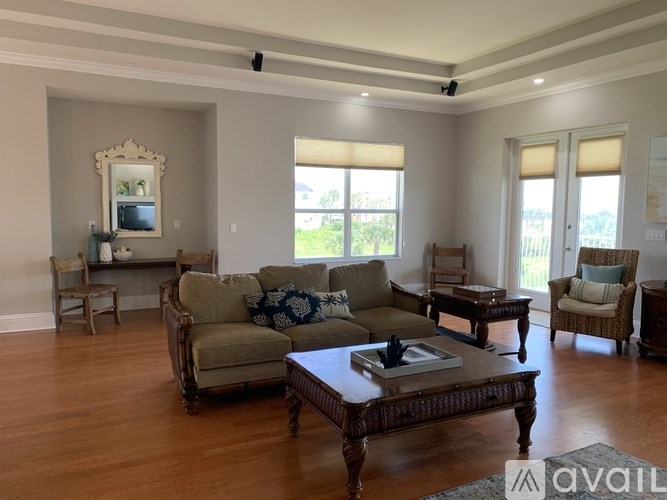 A living room with a couch, chairs, and a coffee table.
