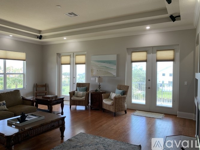 A living room with a couch, chairs, and a coffee table.