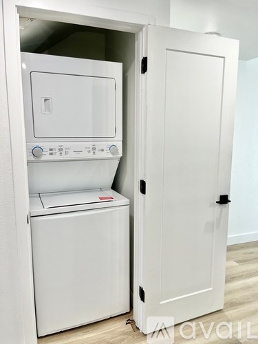 A white oven and microwave are built into a cabinet.