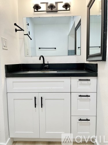 A bathroom with a sink and a mirror.