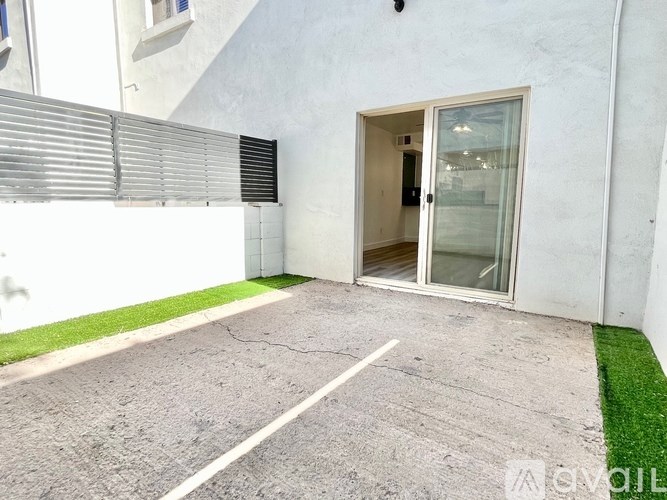 A white building with a glass door and a small window.