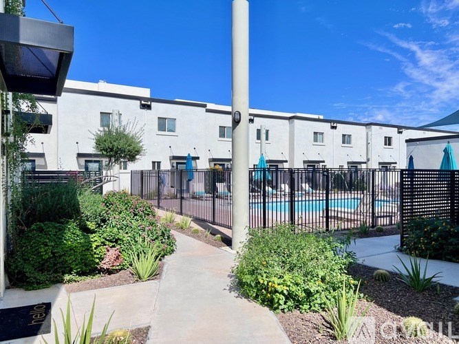 A sunny day at the poolside of a residential building.
