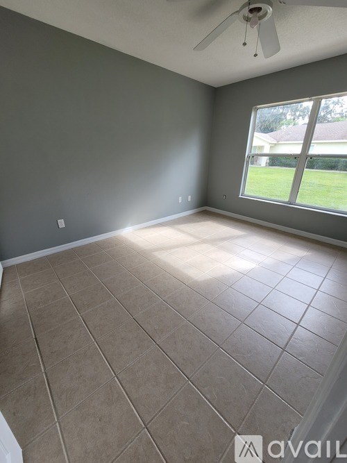 A room with a tiled floor and a ceiling fan.