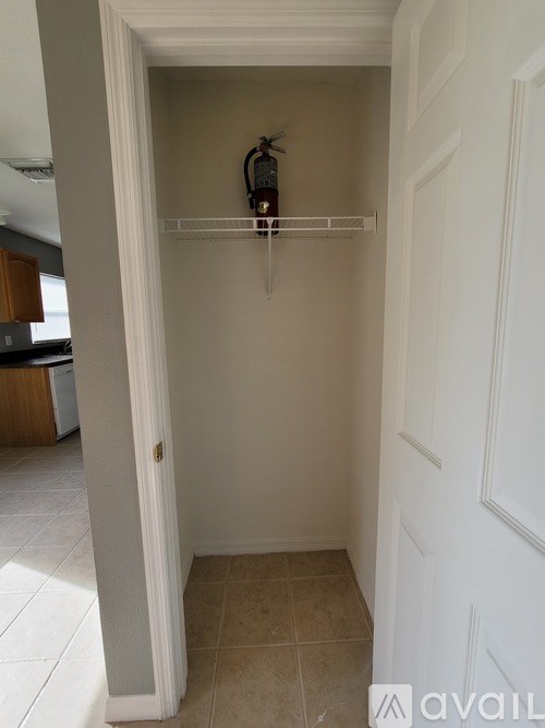 A white door with a shelf above it.