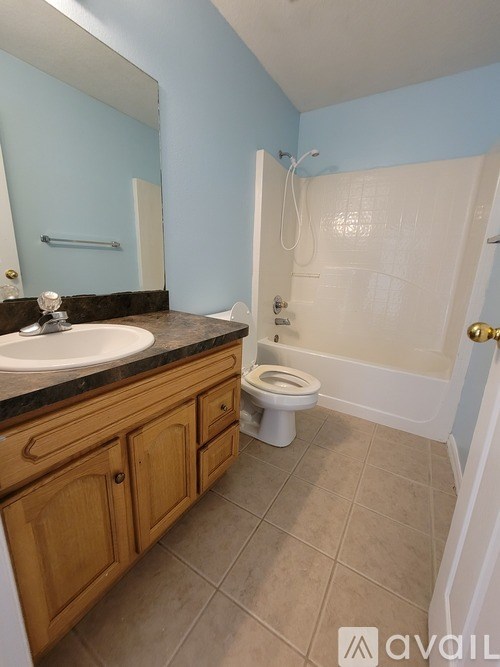 A bathroom with a sink, toilet, and bathtub.