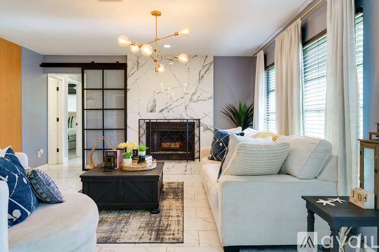 A living room with a fireplace and a sofa.