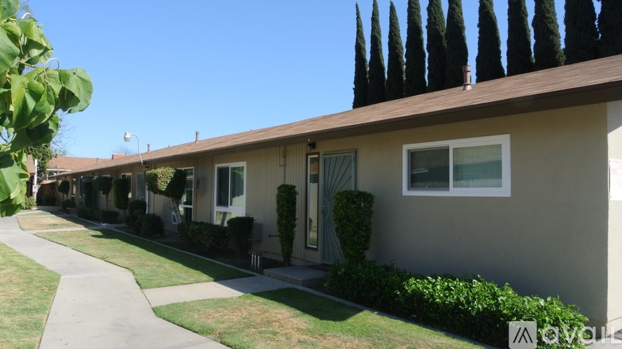 A row of houses with a clear blue sky above them.