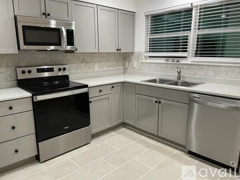A kitchen with a stove, microwave, and dishwasher.