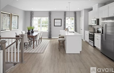 A modern kitchen with white appliances and a dining table with chairs.