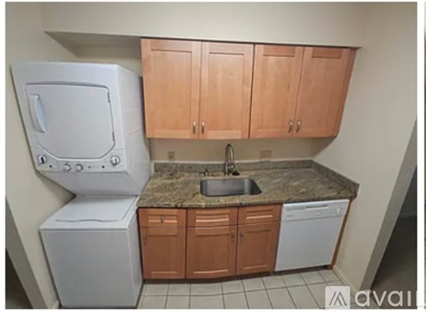 A kitchen with a white dishwasher and a sink.