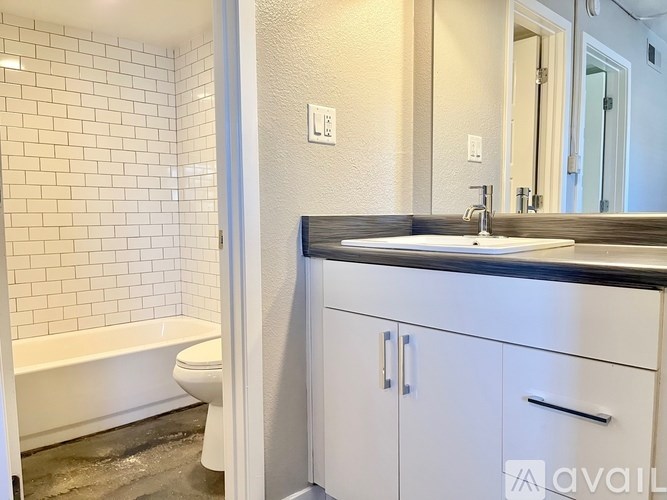 A bathroom with a white tub and sink.