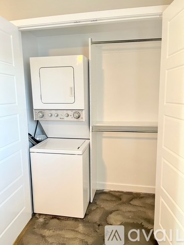 A white dishwasher and oven in a small kitchen.