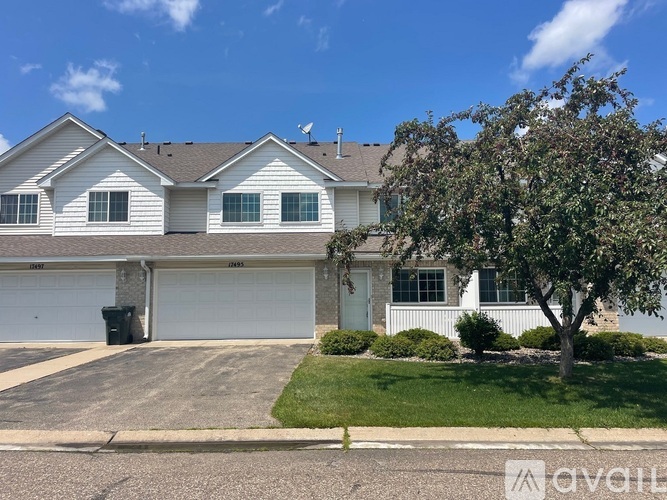 A house with a garage and a driveway in front.