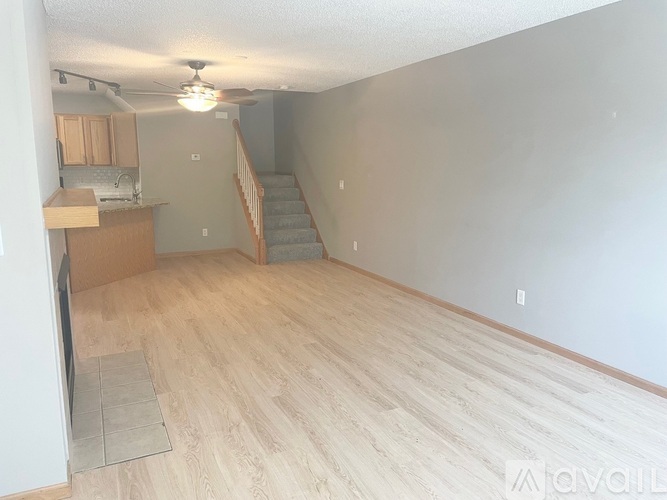 A kitchen with a wooden island in the middle.